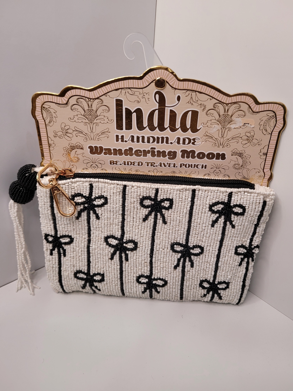 Handmade White Beaded Travel Pouch with Black Bow Pattern